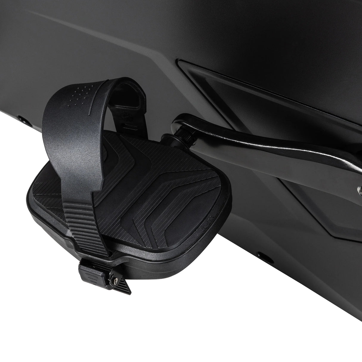 Close-up of the Spirit Fitness CU1000ENT Upright Bike pedal showing the adjustable foot strap, textured non-slip pedal surface, and crank arm connecting to the frame.