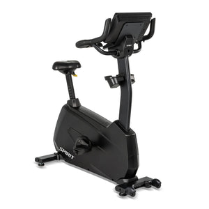 Rear three-quarter view of the Spirit Fitness CU1000ENT Upright Bike showing the back of the touchscreen console, seat, dual water bottle holders, and pedal crank.