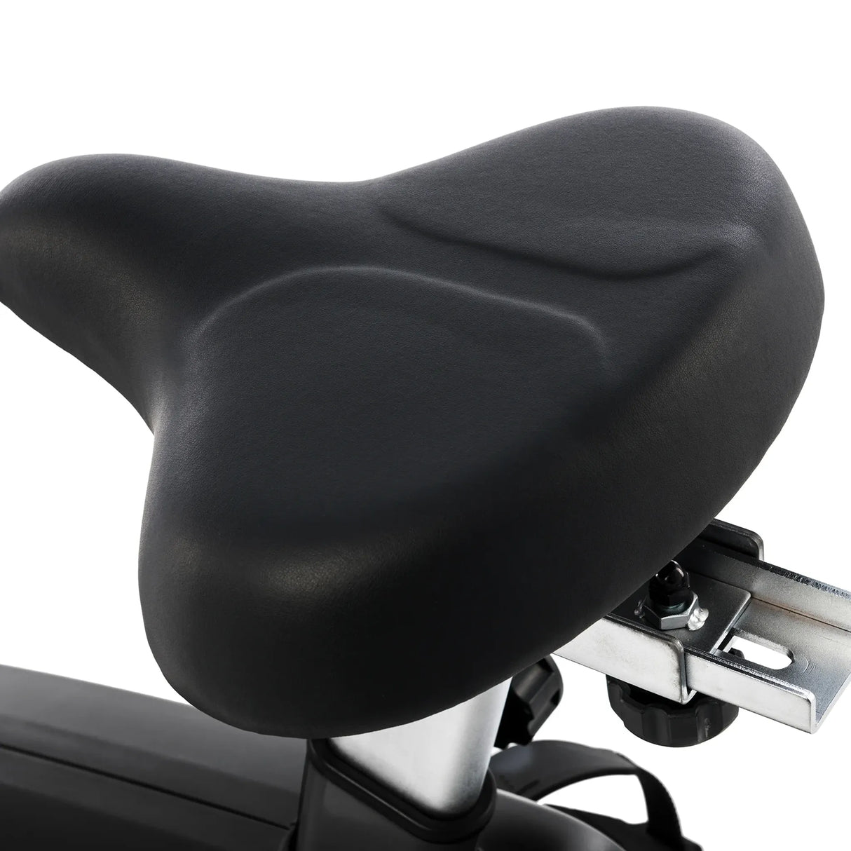 Close-up of the Spirit Fitness CU800 Upright Bike's black, wide, cushioned seat featuring a contoured surface and sturdy metal support bracket.