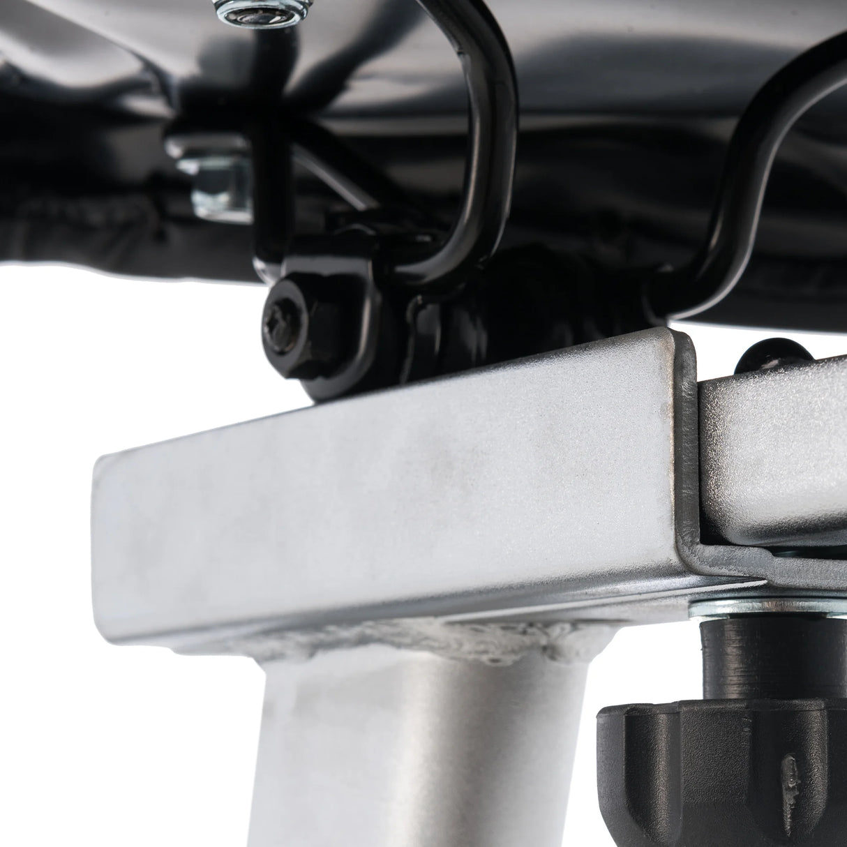 Close-up of bolts and welded joints under the Spirit Fitness CU800 Upright Bike, highlighting black and silver fasteners on its metal structure.
