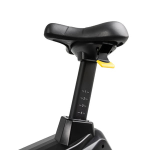 Close-up of the Spirit Fitness CU900 Upright Bike's black seat, featuring an adjustment lever and numbered height markings on the seat post, by Spirit Fitness, shown against a plain white background.
