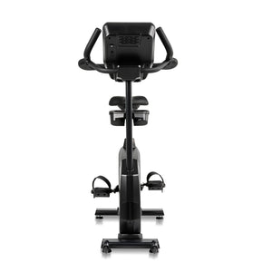 The Spirit Fitness CU900 Upright Bike by Spirit Fitness is shown from the back, highlighting its seat, pedals, handlebars, and display console against a white background.